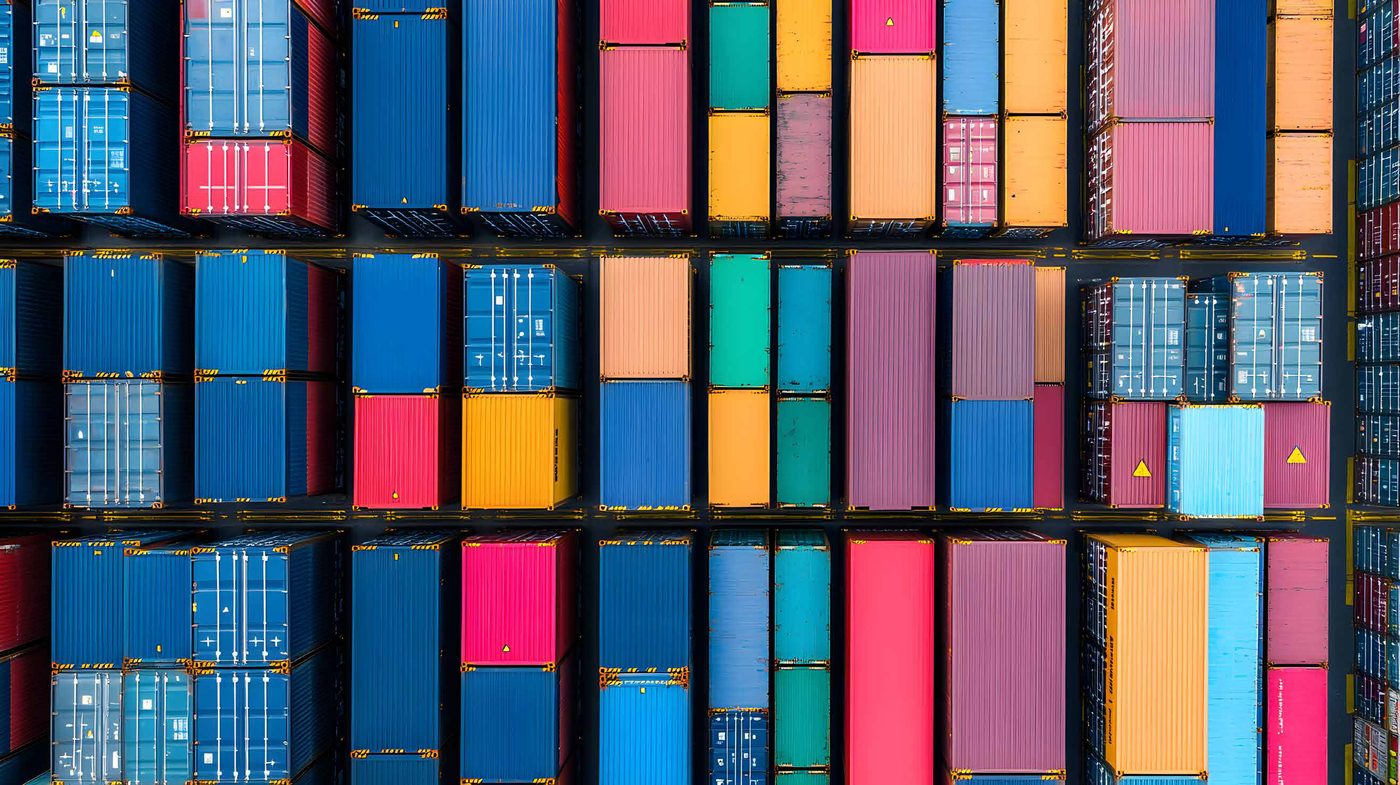 Top-down view of colourful shipping containers stacked on a vessel