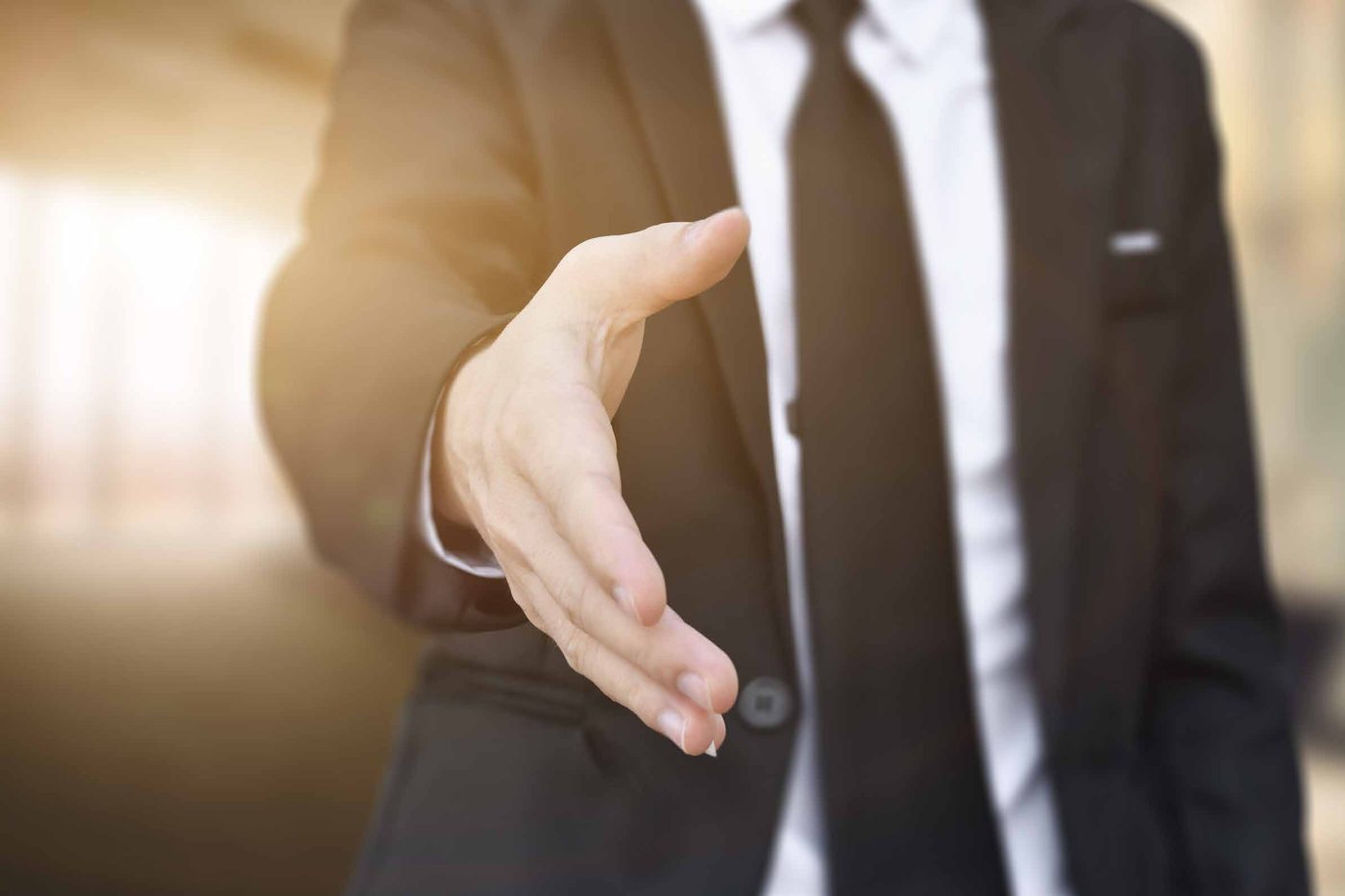 A professional logistics consultant extending a handshake